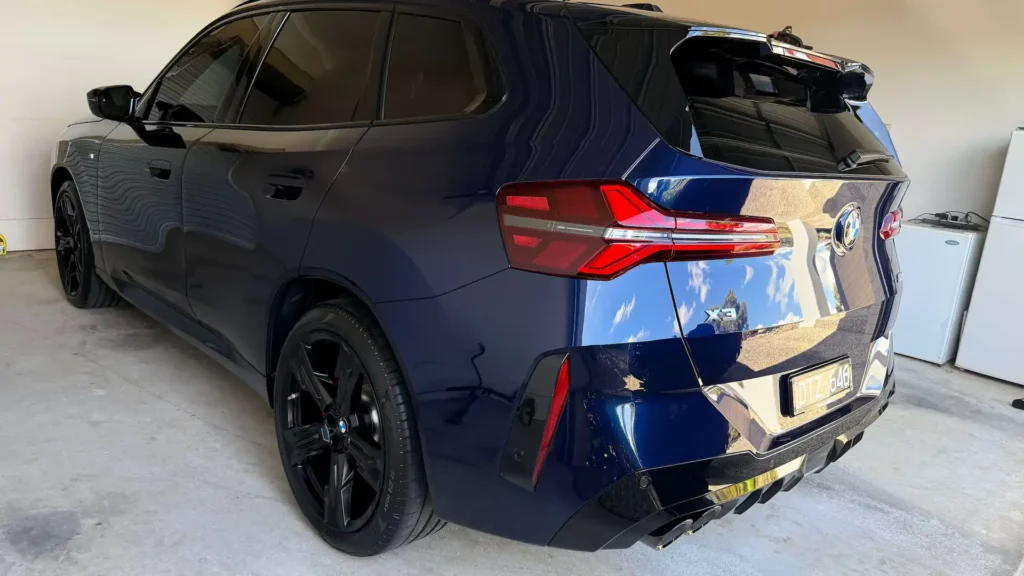 Rear view of a deep blue BMW X3 after a full car detailing service at Melbourne Detailing Studio.